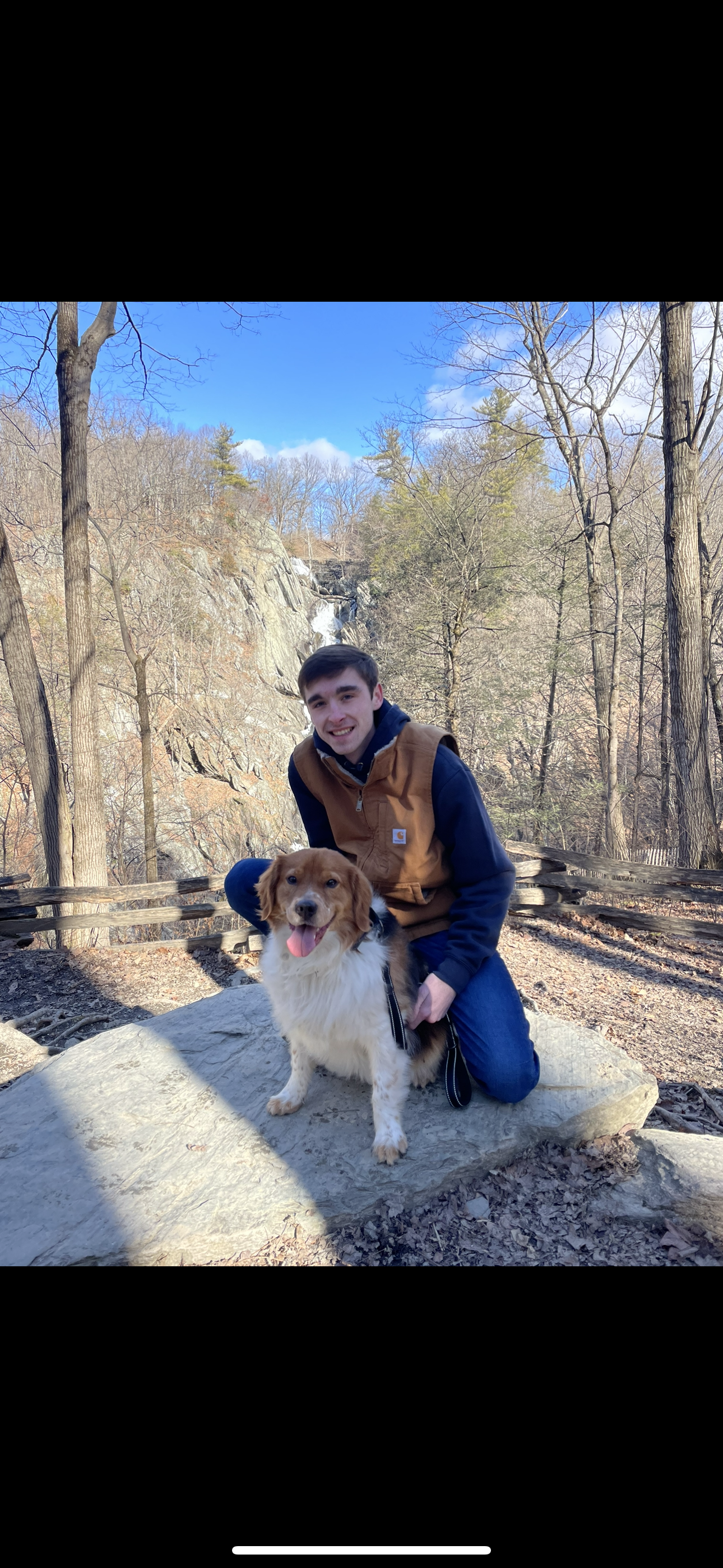 A picture of Aaron and his handsome dog Nash outside at a state park.